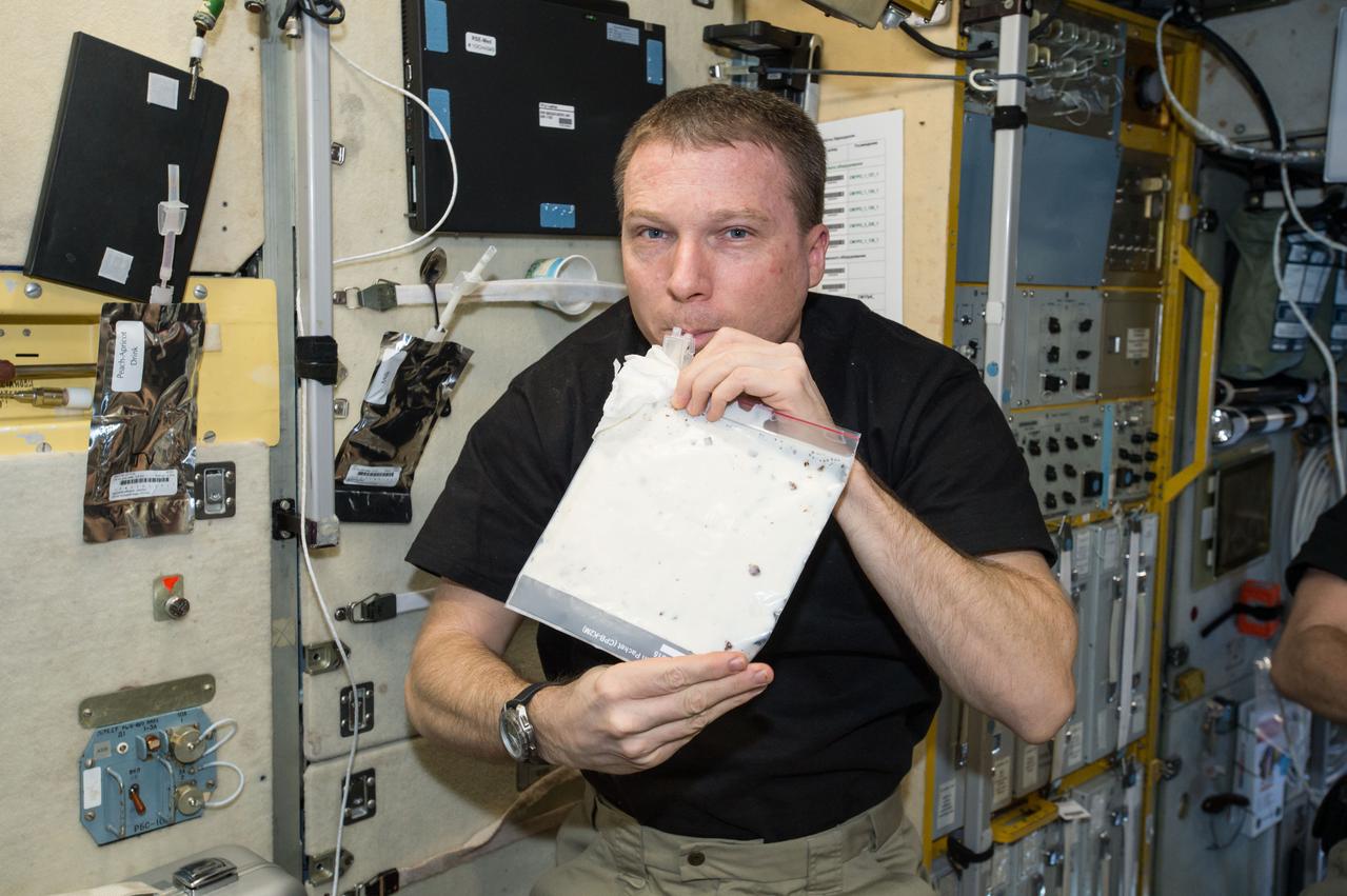 ISS043E182212 (05/08/2015) --- NASA astronaut and Expedition 43 commander Terry Virts takes a drink of his very first milkshake onboard the International Space Station.