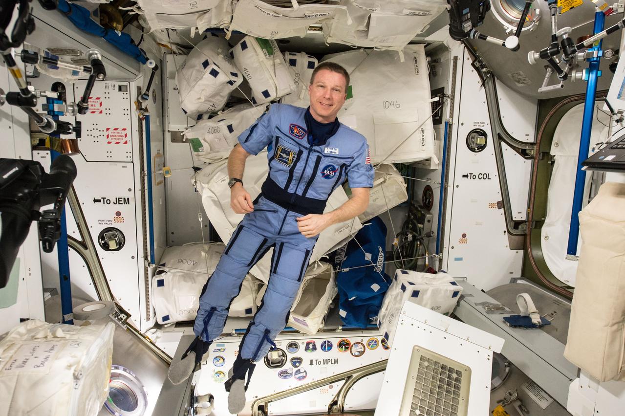 ISS043E188795 (05/12/2015) --- Expedition 43 commander and NASA astronaut Terry Virts shows off a special suit for his preparation process to return to Earth later. Virts tweeted this image with an explanation of the suits purpose on May 12, 2015: “Our "Penguin (пингвин)" suit- it compresses you, to get your body ready for the return to gravity".