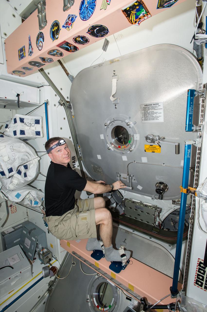 ISS043E256577 (05/26/2015) --- Expedition 43 commander and NASA astronaut Terry Virts is seen here closing the hatch to the Leonardo Permanent Multipurpose Module (PMM.) The PMM was moved on May 27, 2015 from the Unity node to the Tranquility node. This freed up a docking port on the Earth-facing side of Unity for visiting cargo vehicles and was the latest activity in the ongoing upgrades to the station to prepare for future U.S. commercial crew vehicles.