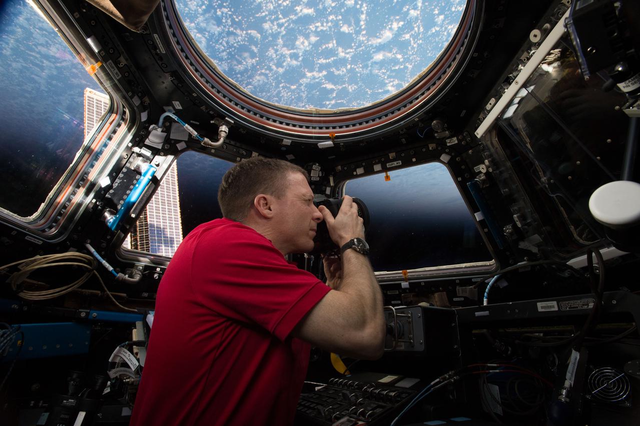 ISS043E276404 (05/31/2015) --- Expedition 43 Commander and NASA astronaut Terry Virts is seen here in the International Space Station’s Cupola module, a 360 degree Earth and space viewing platform. The module also contains a robotic workstation for controlling the station’s main robotic arm, Canadarm2, which is used for a variety of operations including the remote grappling of visiting cargo vehicles.