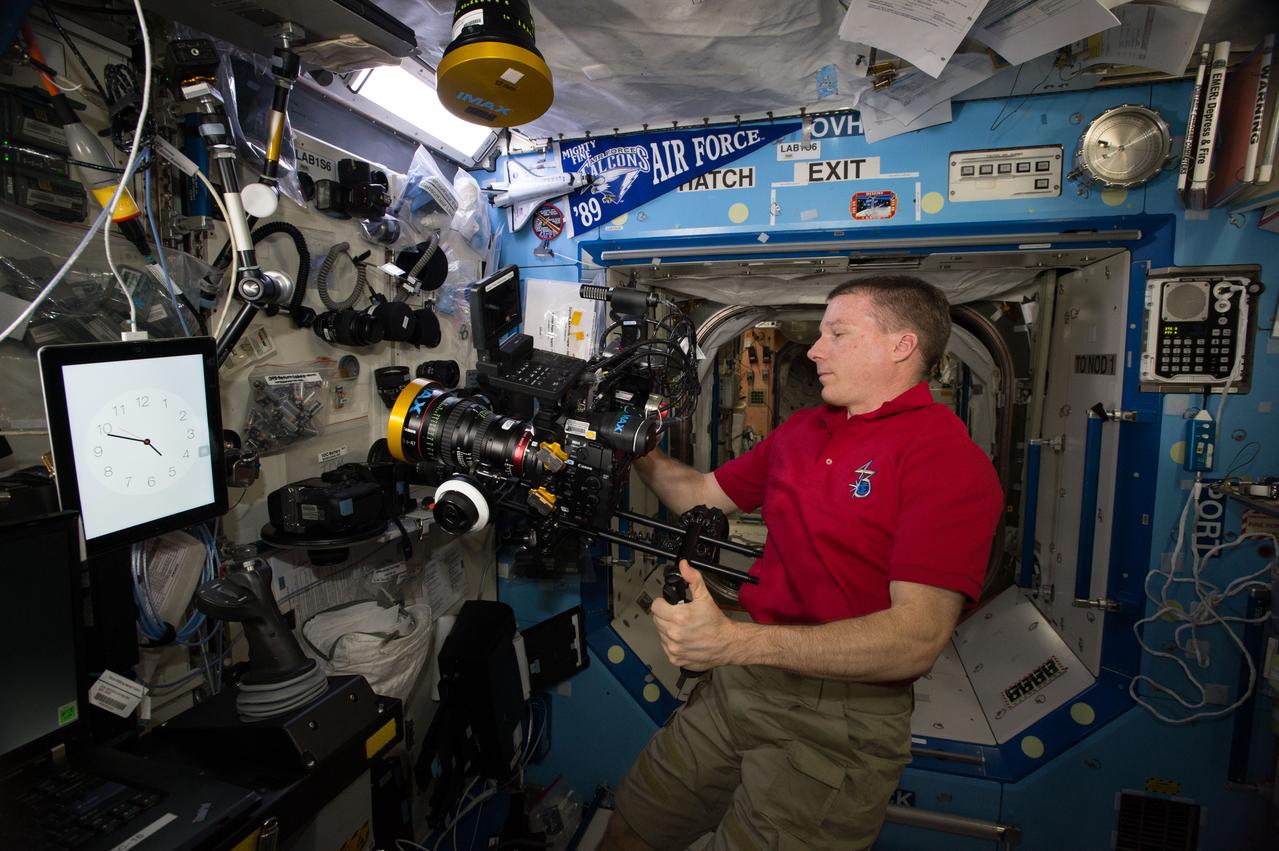 ISS043E276456 (05/31/2015) --- Expedition 43 Commander and NASA astronaut Terry Virts is seen here inside the station’s Destiny laboratory preparing camera equipment for an upcoming documentation session.