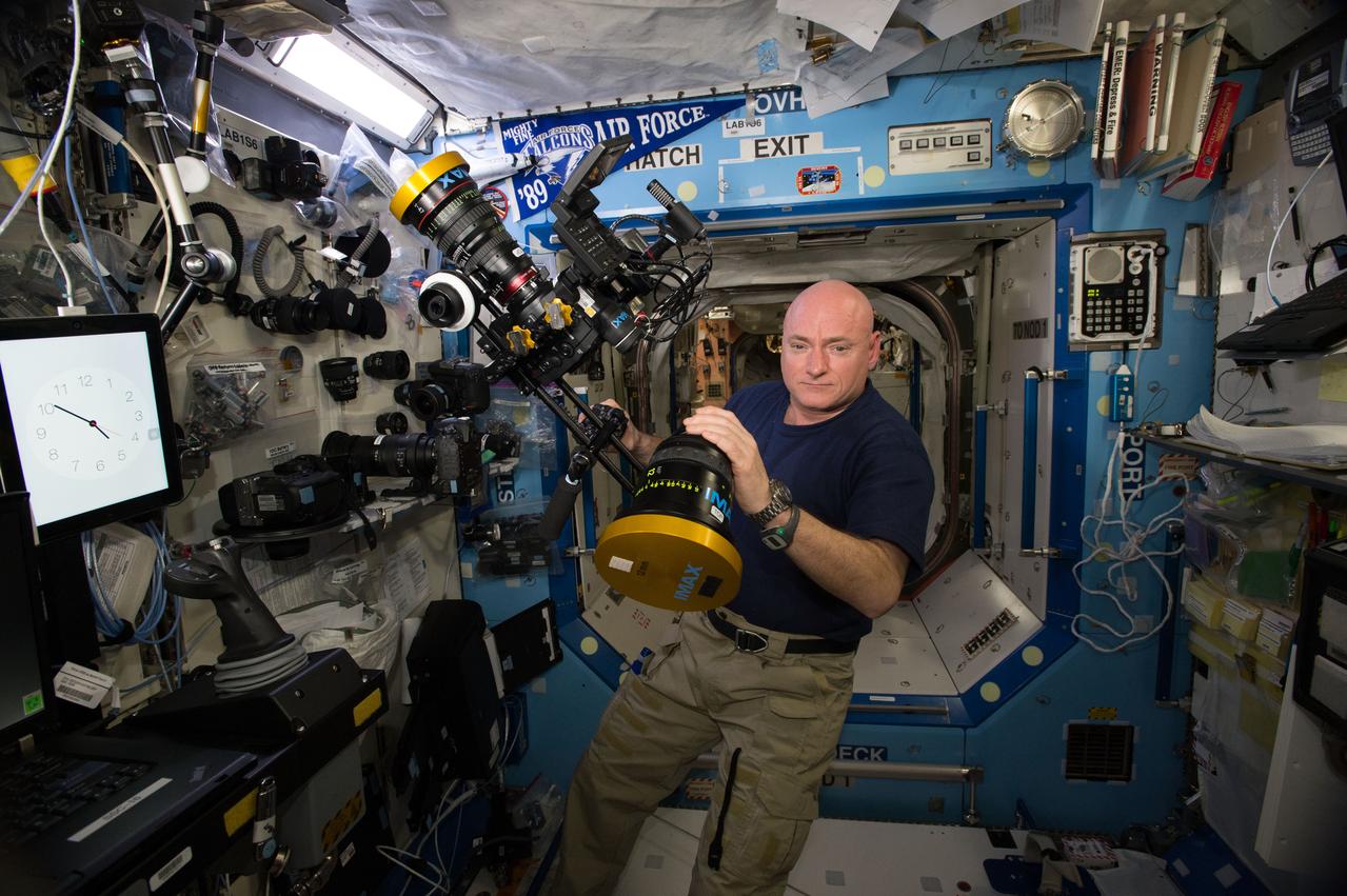 ISS043E276473 (05/31/2015) --- NASA astronaut Scott Kelly is seen here inside the station’s Destiny laboratory preparing camera equipment for an upcoming documentation session.