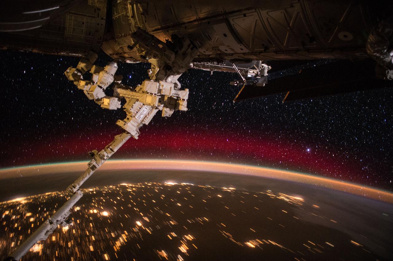 ISS044E002699 (06/23/2015) --- This spectacular view of the Earth with colorful aurora, sparkling city lights, and a rising sun over a background of diamond twinkling stars was taken by members of Expedition 44 on the International Space Station on June 23, 2015.