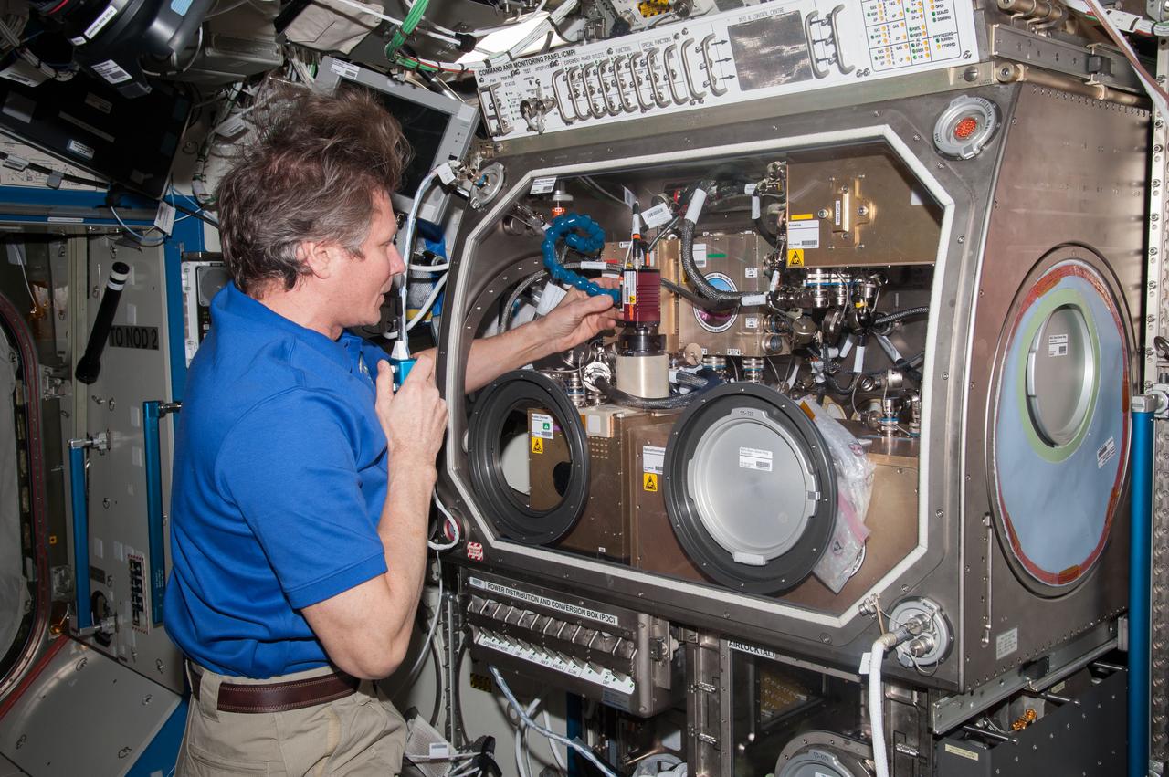iss044e005118 (6/26/2015) --- Cosmonaut Gennady Padalka in the U.S. Laboratory in the process of aligning the Observation Analysis of Smectic Islands in Space (OASIS) Macro Camera. The Observation and Analysis of Smectic Islands In Space (OASIS) studies the unique behavior of liquid crystals in microgravity, including their overall motion and the merging of crystal layers known as smectic islands. Liquid crystals are used for display screens in televisions and clocks, and they also occur in soaps and in cell membranes. The experiment allows detailed studies of the behavior of these structures, and how microgravity affects their unique ability to act like both a liquid and a solid crystal.