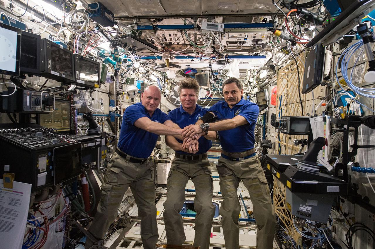 ISS044E013678 (07/15/2015) --- On July 15, 2015 aboard the International Space Station, Expedition 44 crew memebrs Scott Kelly of NASA (left), Expedition Commander and Russian cosmonaut Gennady Padalka (middle), and Russian cosmonaut Mikhail Kornienko (right) commemorated the 40th anniversary of the joint Apollo-Soyuz mission.