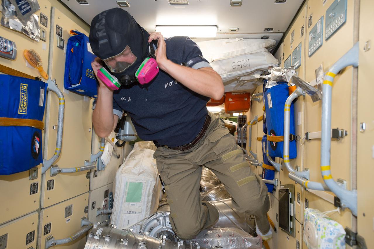 ISS044E025035 (07/29/2015) --- NASA astronaut Kjell Lindgren wears protective breathing apparatus that would be used in the unlikely event of a fire or hazardous chemical leak inside the pressurized air volume of the International Space Station. Familiarization of safety and emergency equipment is standard practice for all newly arrived crew members.