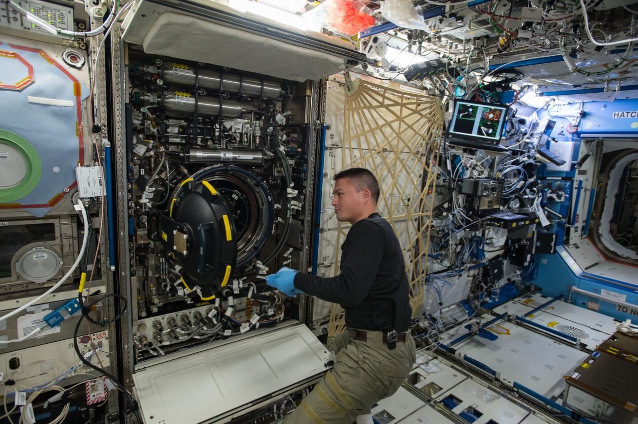 ISS044E064666 (08/20/2015) --- NASA astronaut Kjell Lindgren replaces items inside the Multi-user Droplet Combustion Apparatus found inside the station’s Combustion Integrated Rack (CIR.) The CIR houses hardware capable of performing combustion experiments to further research of combustion in microgravity.