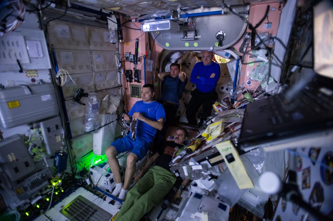 ISS045e019776 (09/19/2015) --- International Space Station Expedition 45 crewmembers watch an advance screening of "The Martian" movie in the Unity Node 1. Clockwise from left, are Russian cosmonauts flight engineers Oleg Kononenko and Sergei Volkov,  NASA astronaut Commander Scott Kelly, and cosmonaut Mikhail Kornienko. This image was released on social media.