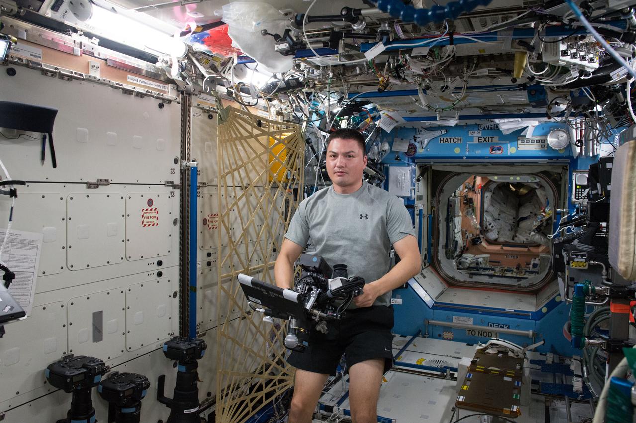 ISS045E028189 (09/24/2015 --- NASA astronaut Kjell Lindgren prepares to film with a RED Dragon camera, capable of capturing Ultra High-Definition (UHD) video. This new capability will allow researchers to acquire high resolution - high frame rate video to provide new insight into the vast array of experiments taking place every day. It will also bestow the most breathtaking views of planet Earth and space station activities ever acquired for consumption by those still dreaming of making the trip to outer space.