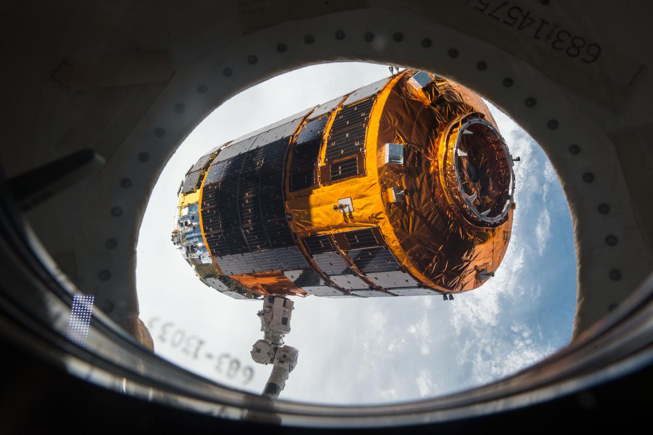 ISS045E033654 (09/28/2015) --- The Japan Aerospace Exploration Agency (JAXA) Kounotori 5 H-II Transfer Vehicle (HTV-5) is seen through a window shortly before release from the International Space Station’s robotic arm, Canadarm2. The cargo vehicle was berthed to the orbiting laboratory for five weeks until it was released on Sept. 28, 2015. HTV-5 delivered almost five tons of hardware and supplies.