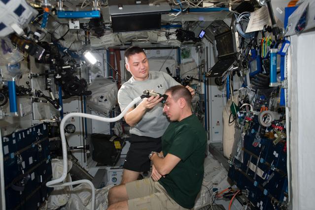 NASA image: Lindgren gives Volkov Haircut