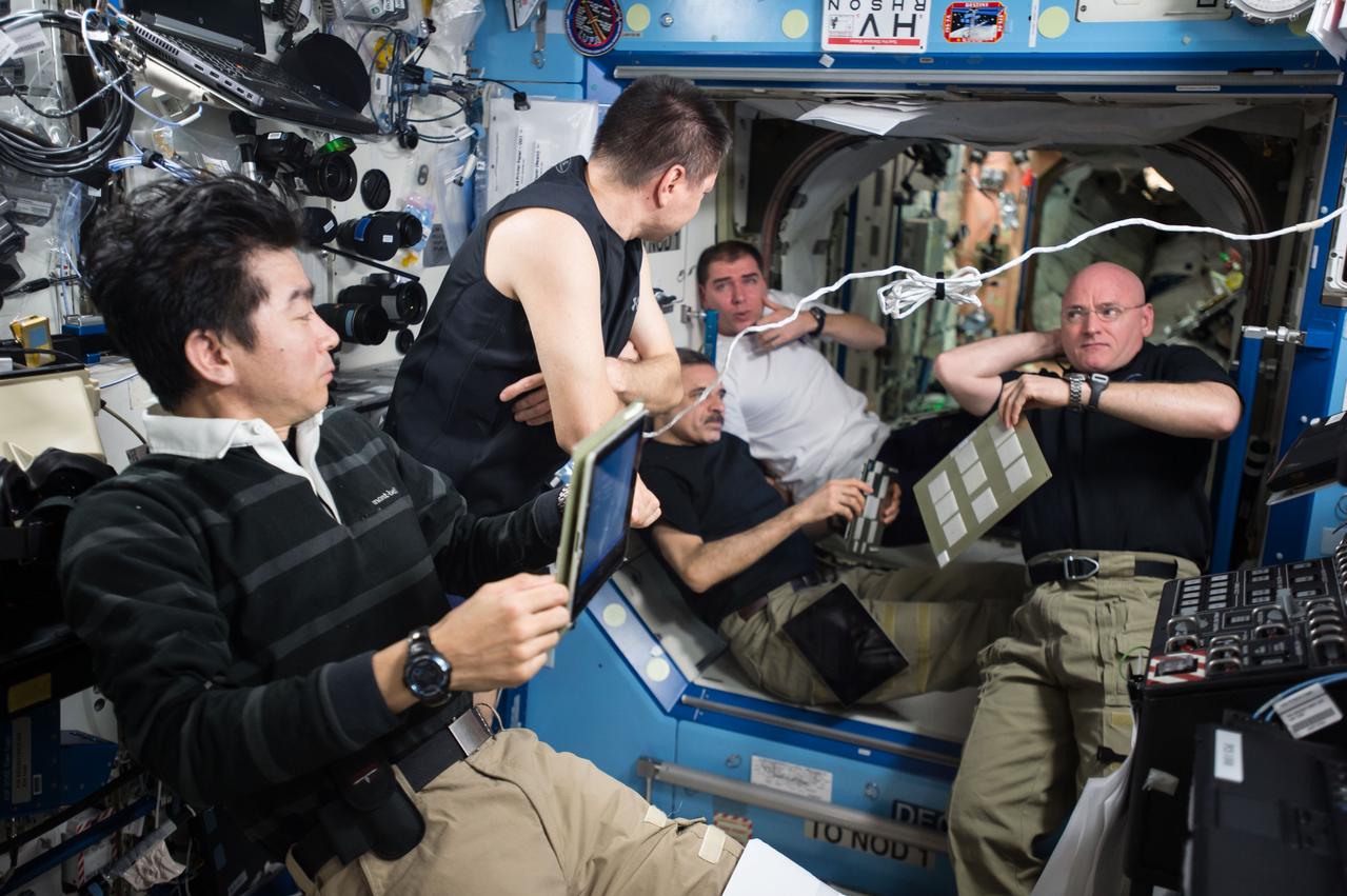 ISS045E075271 (10/19/2015) --- The Expedition 45 crew aboard the International Space Station gather for an emergency situation simulation inside the U.S. Destiny Laboratory. Crews on the station routinely review and practice procedures that would be used in the event of an emergency. Pictured (left to right) is JAXA astronaut Kimiya Yui, Russian cosmonauts Oleg Kononenko, Mikhail Kornienko, and Sergey Volkov, and NASA astronaut and Expedition 45 commander Scott Kelly.