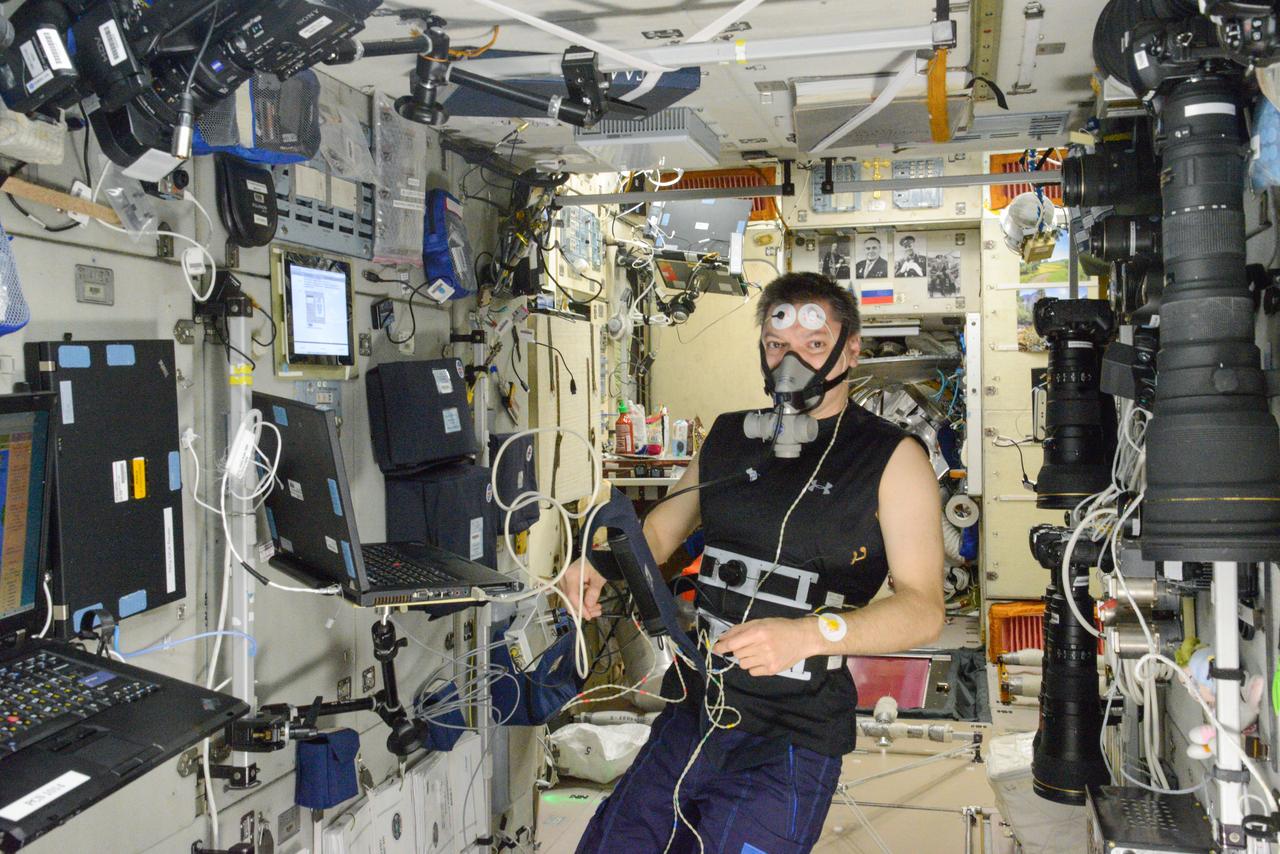 iss045e075926 (10/22/2015) --- Roscosmos cosmonaut Oleg Kononenko is photographed during UDOD experiment operations in the Zvezda Service Module (SM). He is using hardware from the Dykhanie-1 and Sprut-2 Kits.