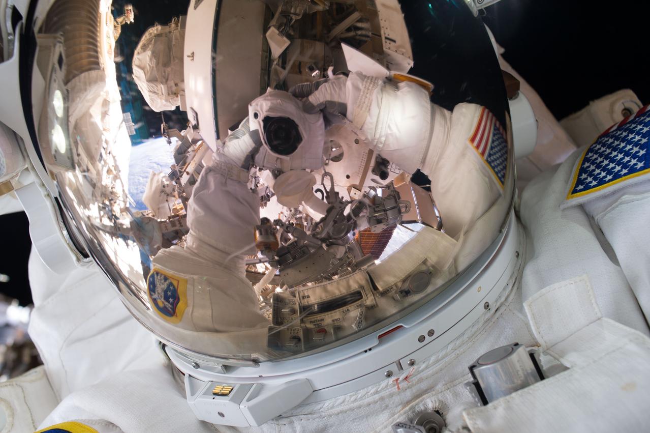 ISS045E082998 (10/28/2015) --- NASA astronaut Scott Kelly snaps a quick space selfie during his first ever spacewalk on Oct 28, 2015. Kelly and NASA astronaut Kjell Lindgren worked outside for seven hours and 16 minutes on a series of tasks to service and upgrade the International Space Station. They wrapped a dark matter detection experiment in a thermal blanket, lubricated the tip of the Canadarm2 robotic arm and then routed power and data cables for a future docking port.