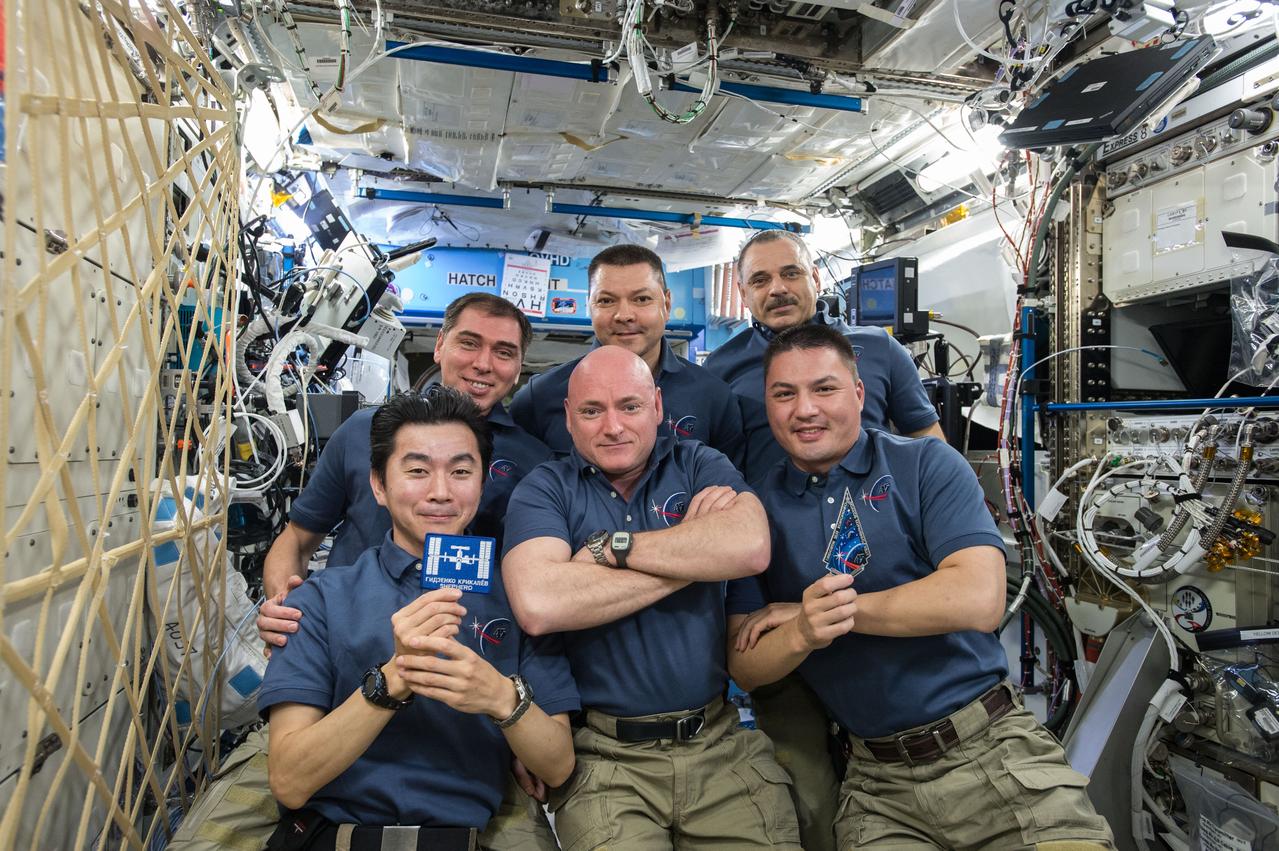 ISS045e172844 (11/02/2015) --- NASA astronaut and Expedition 45 Commander Scott Kelly (front row middle), gathers the rest of the crew on board the International Space Station on Nov. 2nd, 2015. The next homeward-bound astronauts, NASA’s Kjell Lindgren (front row right) and JAXA’s Kimiya Yui  (front row left), will return to the Earth with Soyuz Commander Russian cosmonaut Oleg Kononenko (rear center) on Dec.11, 2015, officially ending the Expedition 45 mission.  Russian cosmonaut Sergey Volkov (rear left) stays on board the station joining Expedition 46. Meanwhile Scott Kelly is also staying on in the station as part of the One-Year in space mission until March with fellow One-Year crew member cosmonaut Mikhail Kornienko (rear right).