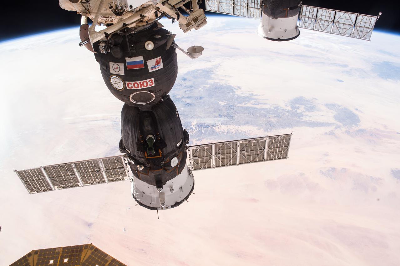 ISS046e004535 (01/03/2016) --- Earth observation taken during a day pass by NASA astronaut Scott Kelly aboard the International Space Station. A Russian Soyuz spacecraft dominates the center of the view as it sits docked to the station. Kelly tweeted this image with the message:  "Day 282. Soyuz silhouette and #sunset colors of our magnificent #Earth. #GoodNight from @space_station! #YearInSpace".