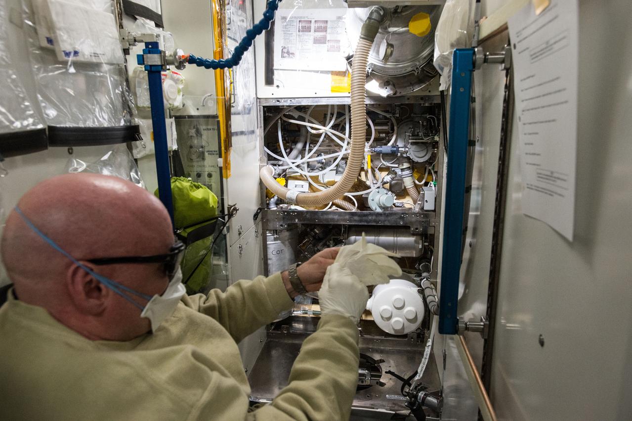 ISS046e005831 (01/07/2016) --- Expedition 46 Commander and NASA astronaut Scott Kelly works to clean up a leak in the Waste and Hygiene Compartment aboard the International Space Station. Crew members are routinely called on for maintenance efforts across the orbiting laboratory as they work to keep their various life support systems in working order.