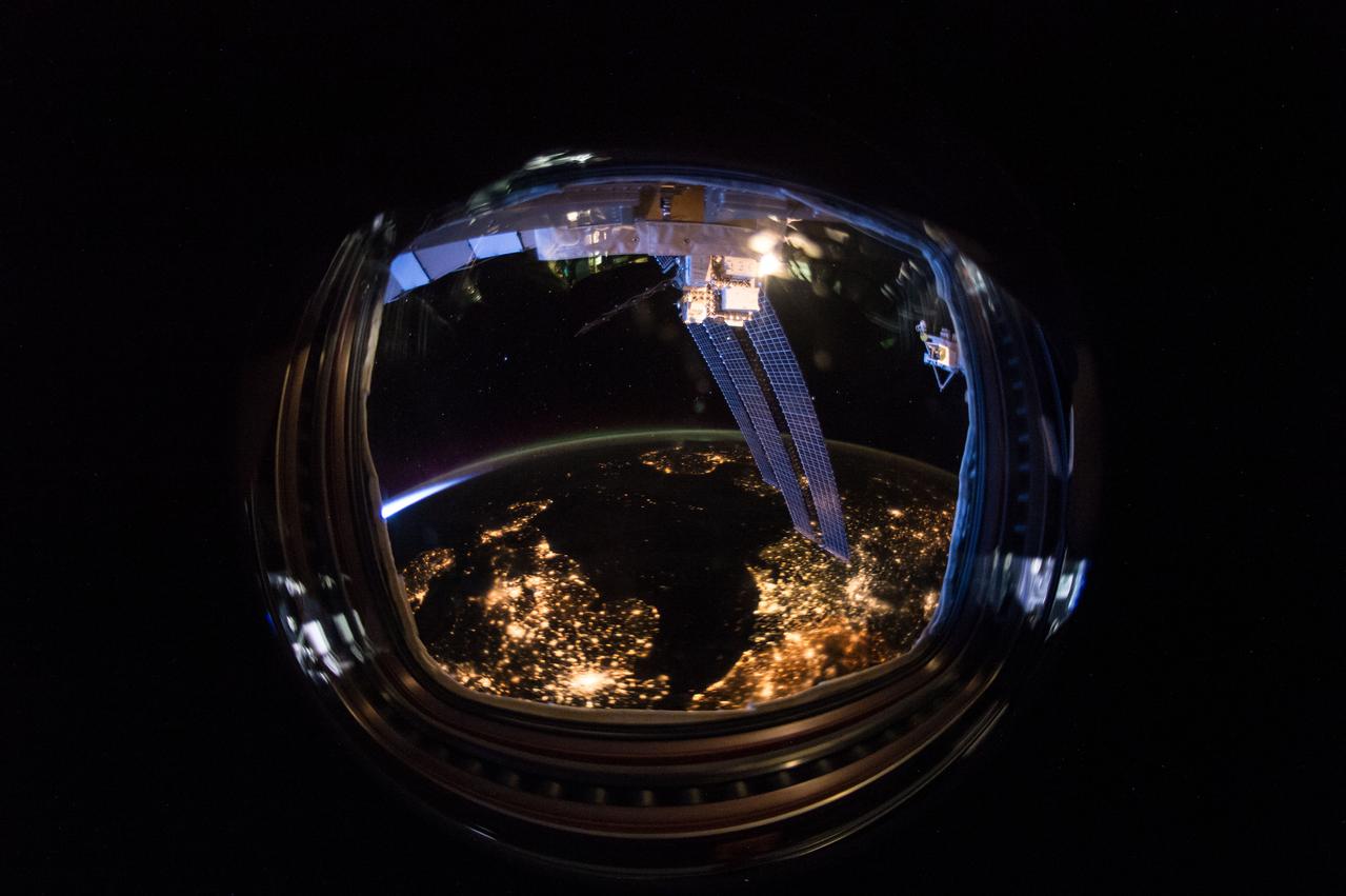 ISS046e040151 (02/11/2016) --- This wide fisheye lens night view of the Earth was taken aboard the International Space Station on Feb 11, 2016 by the crew of Expedition 46. Some of the stations solar array juts down into the image on the left side.