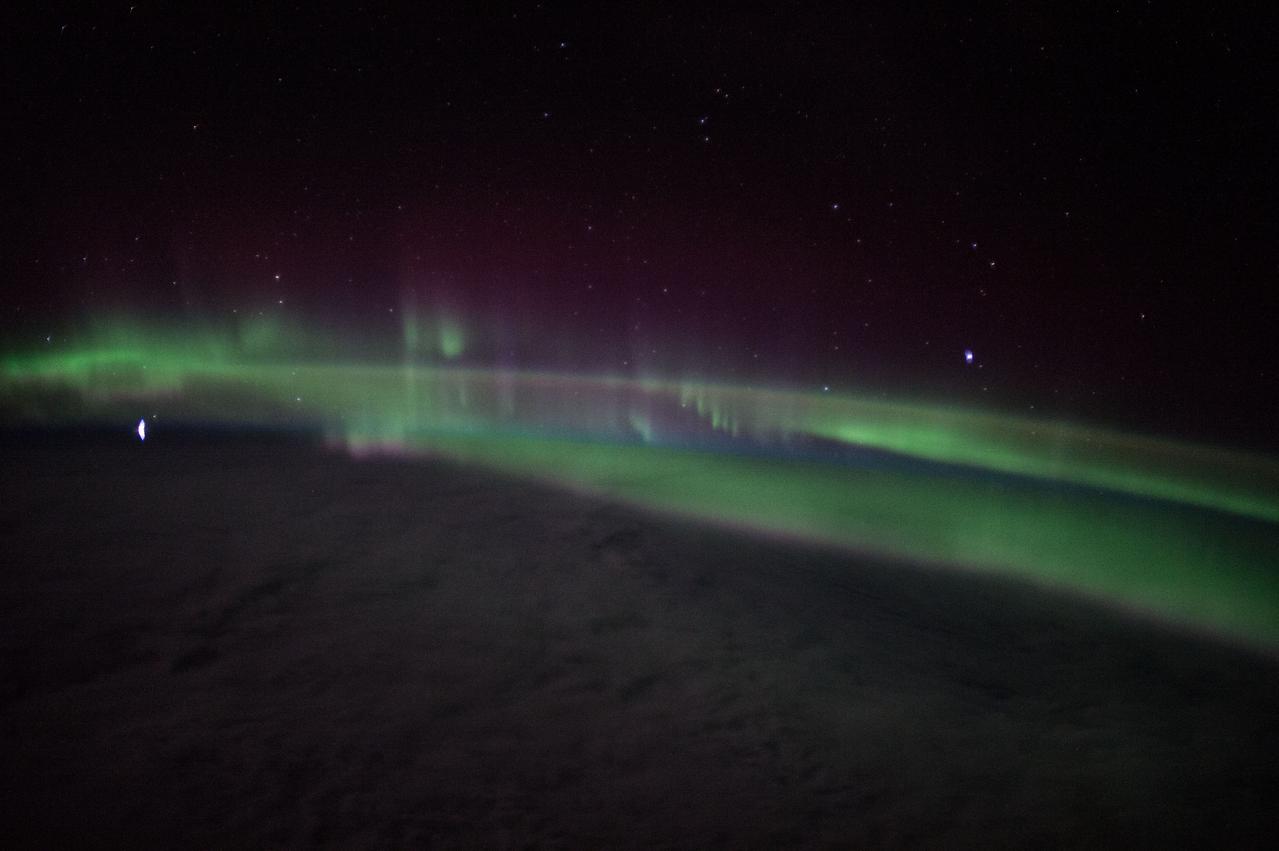 ISS047e000320 (02/17/2016) --- Aurora flashing over the Earth as the International Space Station orbits around the planet. NASA astronaut Tim Kopra sent this mesmerizing image out with the comment " "Stunning #aurora tonight- felt like we were enveloped in green light when we passed through this band @Space_Station". "