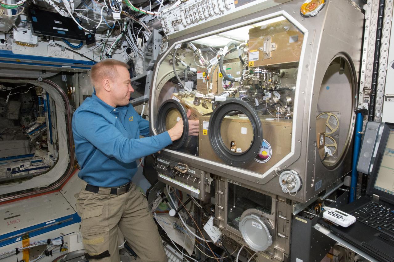 iss047e012491 (03/21/2016) --- NASA astronaut Tim Kopra stows hardware from the OASIS experiment aboard the International Space Station. OASIS, which stands for Observation and Analysis of Smectic Islands In Space, studies the unique behavior of liquid crystals in microgravity.