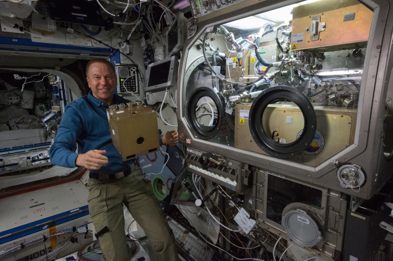 ISS047e012492 (03/21/2016) --- NASA astronaut Tim Kopra stows hardware from the OASIS experiment aboard the International Space Station. OASIS, which stands for Observation and Analysis of Smectic Islands In Space, studies the unique behavior of liquid crystals in microgravity.
