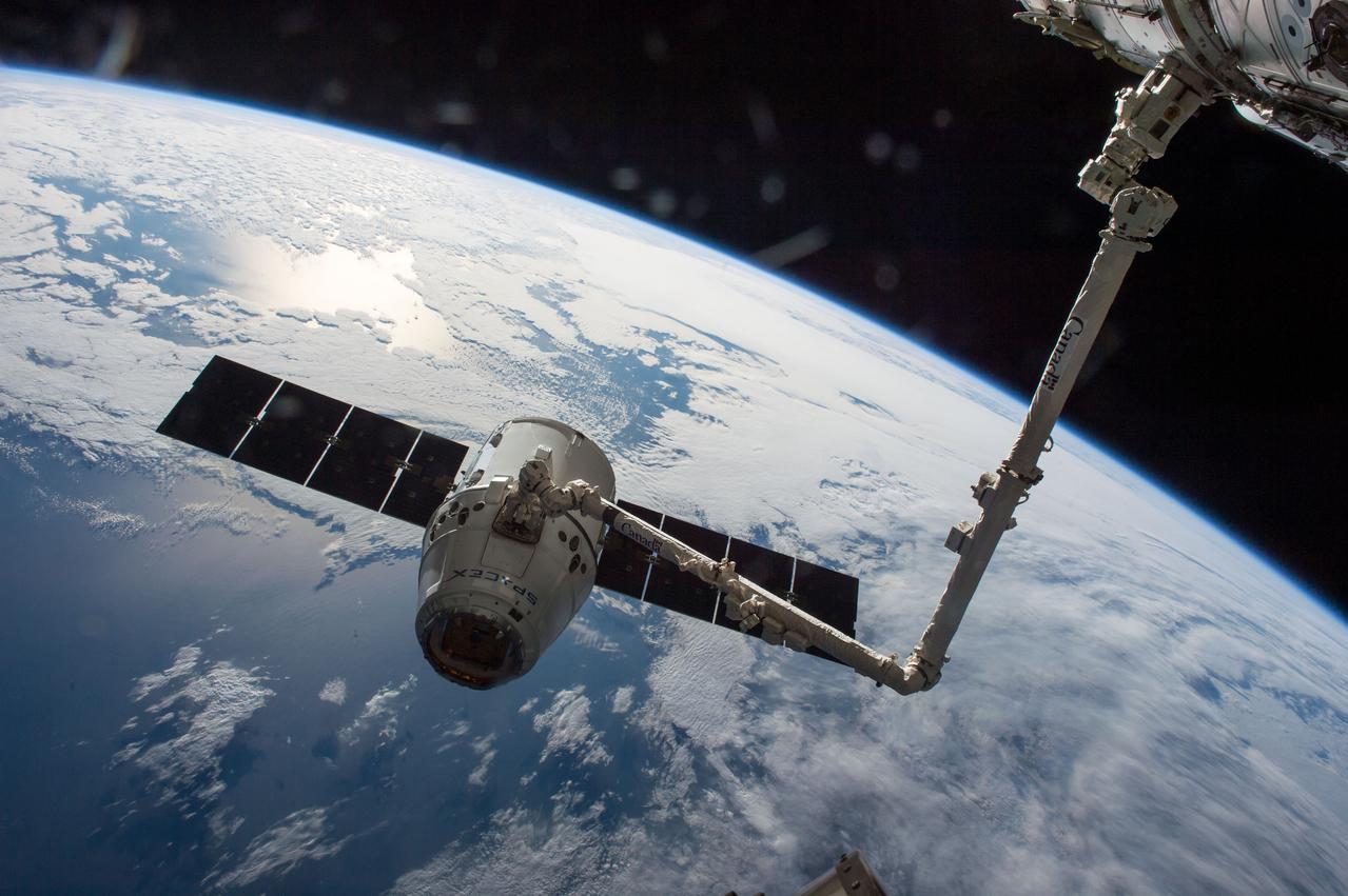 iss047e050978 (4/10/2016) --- The SpaceX Dragon cargo spaceship is grappled by the International Space Station’s Canadarm2. The spacecraft is delivering about 7,000 pounds of science and research investigations, including the Bigelow Expandable Activity Module, known as BEAM. Dragon’s arrival marked the first time two commercial cargo vehicles have been docked simultaneously at the space station. Orbital ATK’s Cygnus spacecraft arrived to the station just over two weeks ago. With the arrival of Dragon, the space station ties the record for most vehicles on station at one time – six.