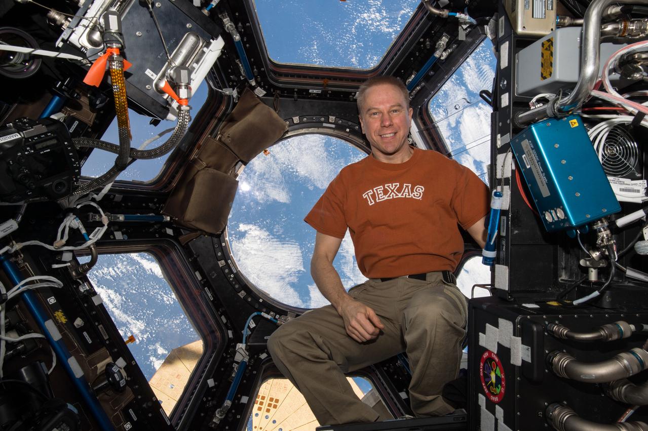 ISS047e111084 (05/10/2016) --- NASA astronaut Tim Kopra poses inside the cupola module onboard the International Space Station. Kopra, who was born in Austin, Texas, is the commander of Expedition 47 and previously served as a flight engineer during Expeditions 46 and 20.
