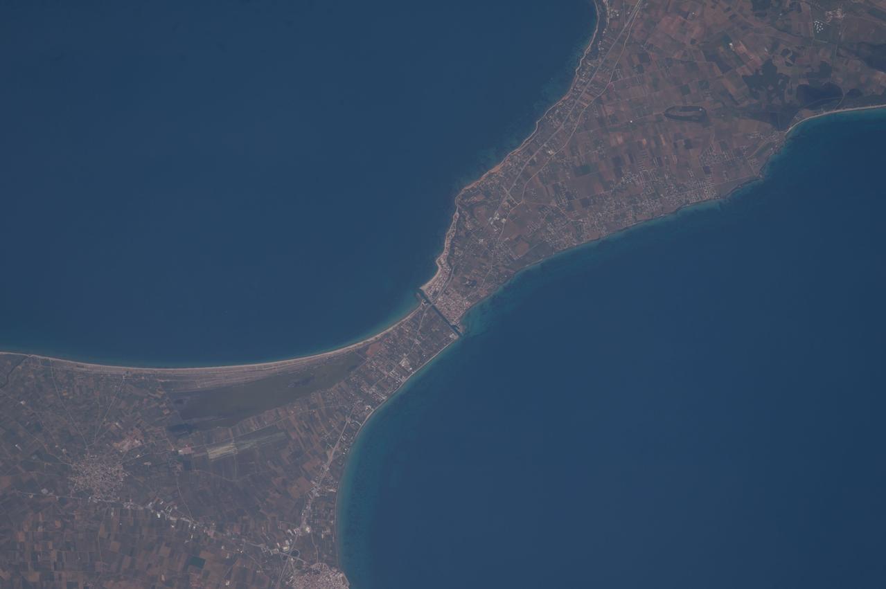 ISS047e115879 (05/13/2016) --- NASA astronaut Jeff Williams captured this image of the ancient Potidea canal in Greece from the International Space Station. For 2,000 years this canal has connected the Thermaikos and Toronaios Gulfs. Williams posted the photograph to his Twitter account May 13, 2016 saying, "Coastal currents and erosion over 2,000 years appear to have displaced the two sides of this isthmus," which may explain the coastline's misalignment".