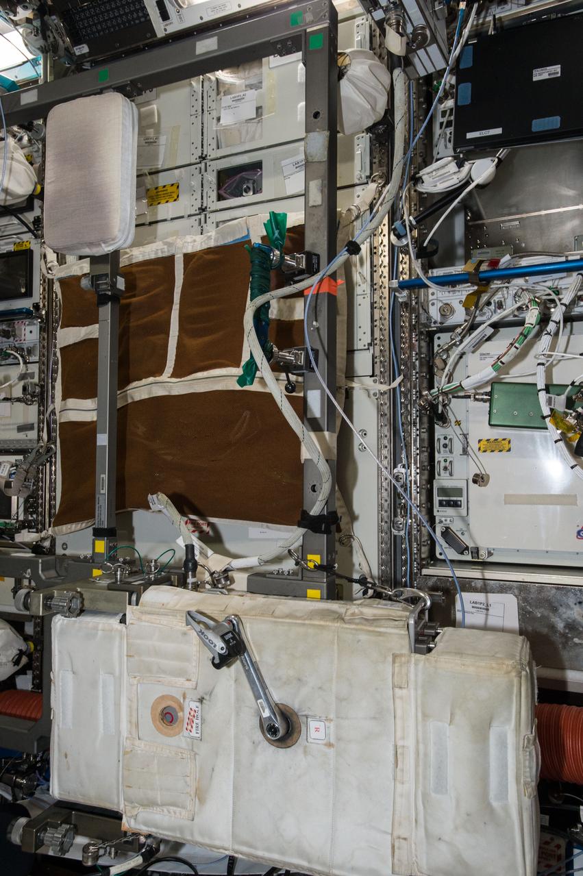 iss048e004552 (6/20/2016) --- Image taken to document re-installation of the Cycle Ergometer with Vibration Isolation and Stabilization (CEVIS) at LAB1P3 following inflight maintenance (IFM) on the Direct Current to Direct Current Converter Unit-1 (DDCU-1) Rack. Image was taken in the Destiny U.S. Laboratory.