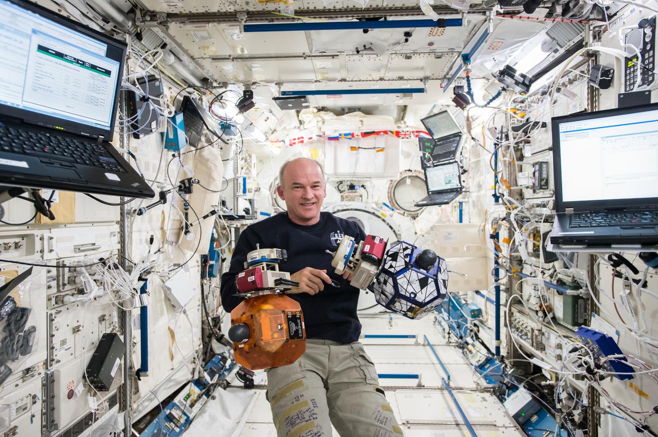 iss048e017435 (6/30/2016) --- Commander Jeff Williams monitors bowling ball-sized internal satellites known as SPHERES (Synchronized Position Hold, Engage, Reorient, Experimental Satellites) during a maintenance run in the Japanese Kibo Laboratory Module.