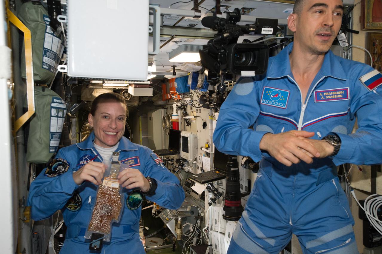 ISS048e025150 (07/09/2016) --- NASA astronaut Kate Rubin (left), tries her first meal aboard the International Space Station along with Expedition 48 crew member Roscosmos cosmonaut Anatoly Ivanishin.