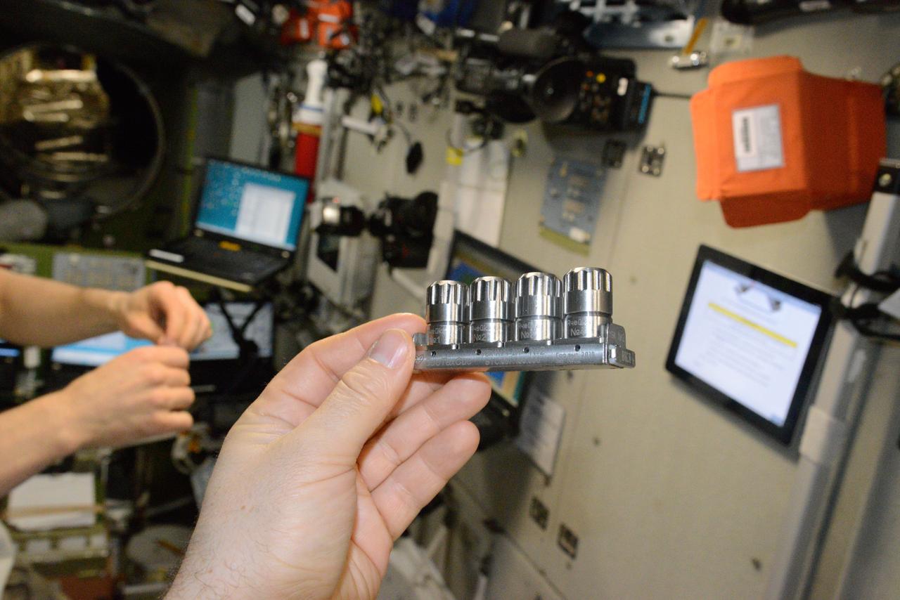 iss048e038162 (7/19/2016) --- The hand of a crewmember displays Luch-2M Multipurpose Crystallization Cassette (УБК) No. 2 during Struktura-Luch-2M (Structure-Beam-2M) experiment hardware activation and deployment. Image was taken in the Zvezda Service Module (SM) aboard the International Space Station (ISS). Struktura is a study of protein crystallization processes and growth of single crystals which are suitable for X-ray structural analysis and structural decoding.
