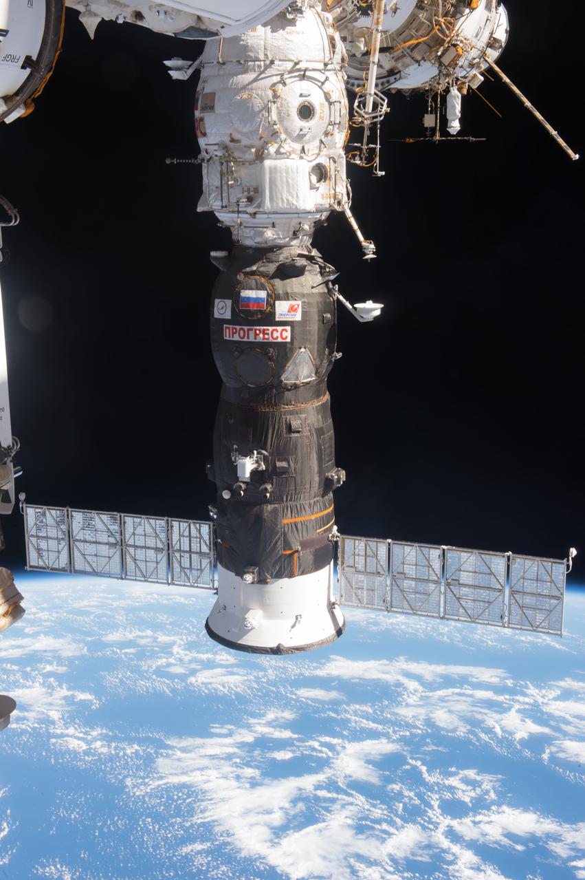 View of the Progress 64P spacecraft docked to Pirs Docking Compartment (DC1), taken against a backdrop of Earth and space.