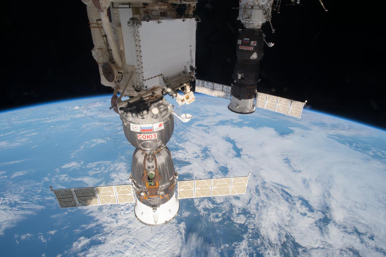 View of the docked Soyuz MS-01 (47S) and Progress 64P spacecraft against a backdrop of Earth and space.