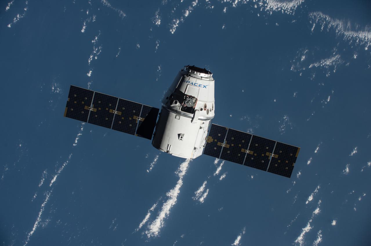 The SpaceX Dragon Commercial Resupply Services-9 (CRS-9) spacecraft approaches the ISS for rendezvous and grapple operations. Earth provides the backdrop for this image.