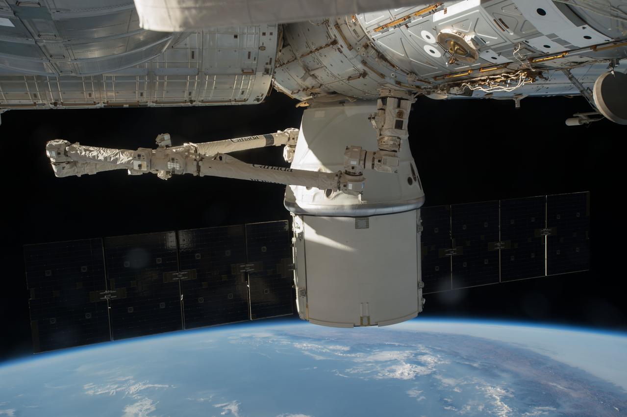 ISS048e042926 (07/24/2016) --- The SpaceX Dragon is attached to the International Space Station, while inside the station the crew of Expedition 48 continue to off load the nearly 5000 pounds of supplies, hardware and experiments.