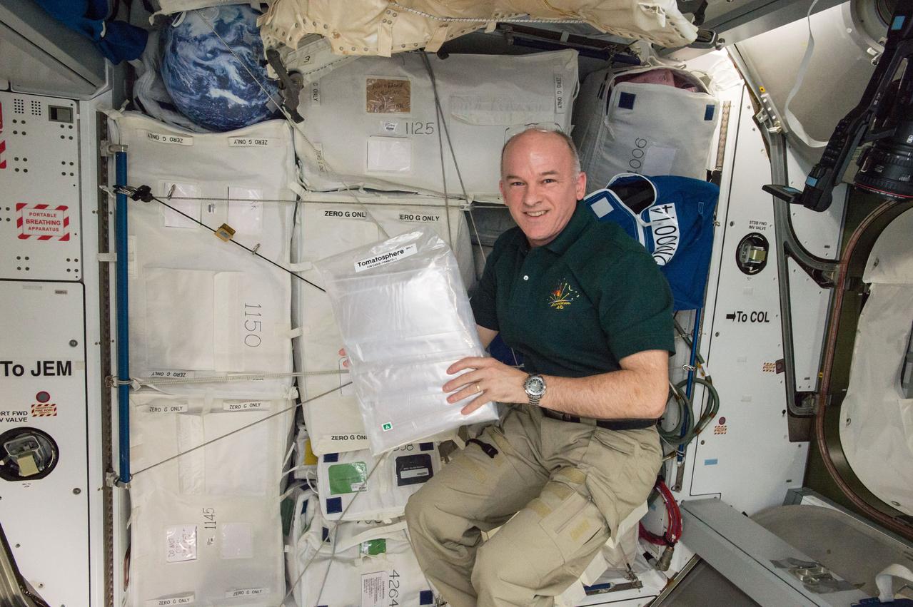iss048e045799 (7/22/2016) --- NASA astronaut Jeff Williams poses for a photo with the Tomatosphere-US payload. Image was taken in the Harmony Node 2. Tomatosphere-US provides K-12 classrooms with tomato seeds from space to use in a blind germination study. Participating classes receive two sets of seeds, a control group from the ground and seeds flown in space or subjected to simulated space conditions. When teachers and students submit the results of their experiment, they learn the source of each set of seeds and can compare their data with other classroom experiments around the country.