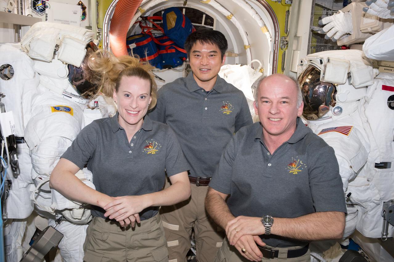 ISS048e057395 (08/14/2016) --- NASA astronauts Kate Rubins (left) and Jeff Williams (right) are joined by JAXA (Japan Aerospace Exploration Agency) astronaut Takuya Onishi inside the Quest airlock as they prepare spacesuits for upcoming spacewalks.