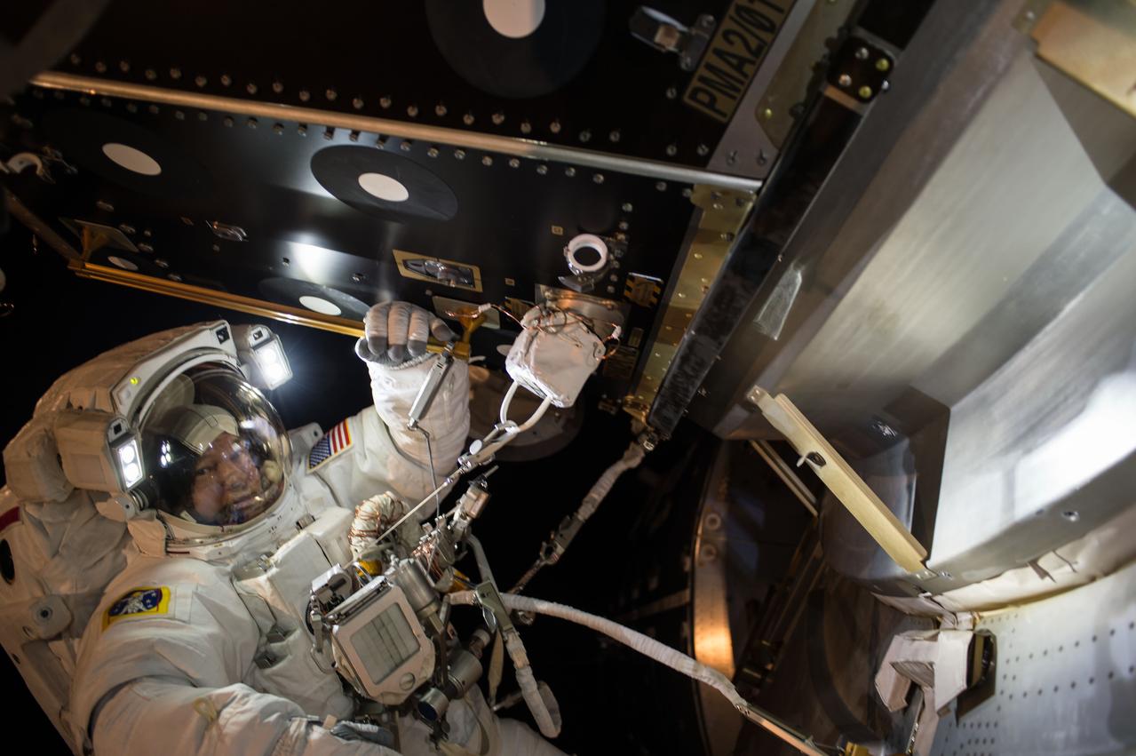 Extravehicular crewmember 1 (EV1) Jeff Williams pauses for a photo after installing a Hemispherical (Hemi) Reflector Cover on Pressurized Mating Adapter 2 (PMA-2) during Extravehicular Activity 36 (EVA 36).