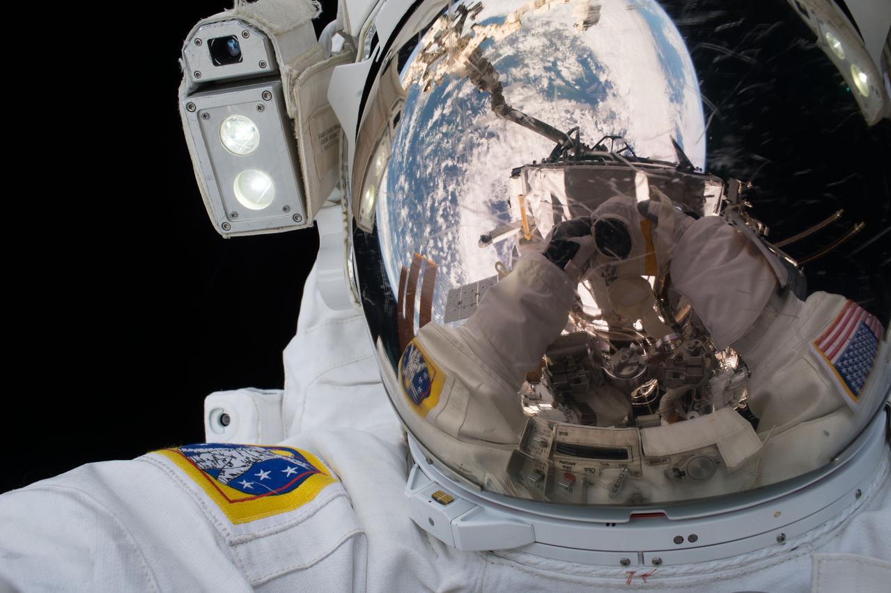 The camera is reflected in his helmet visor as Extravehicular crewmember 1 (EV1) Jeff Williams takes a self-portrait during Extravehicular Activity 36 (EVA 36).