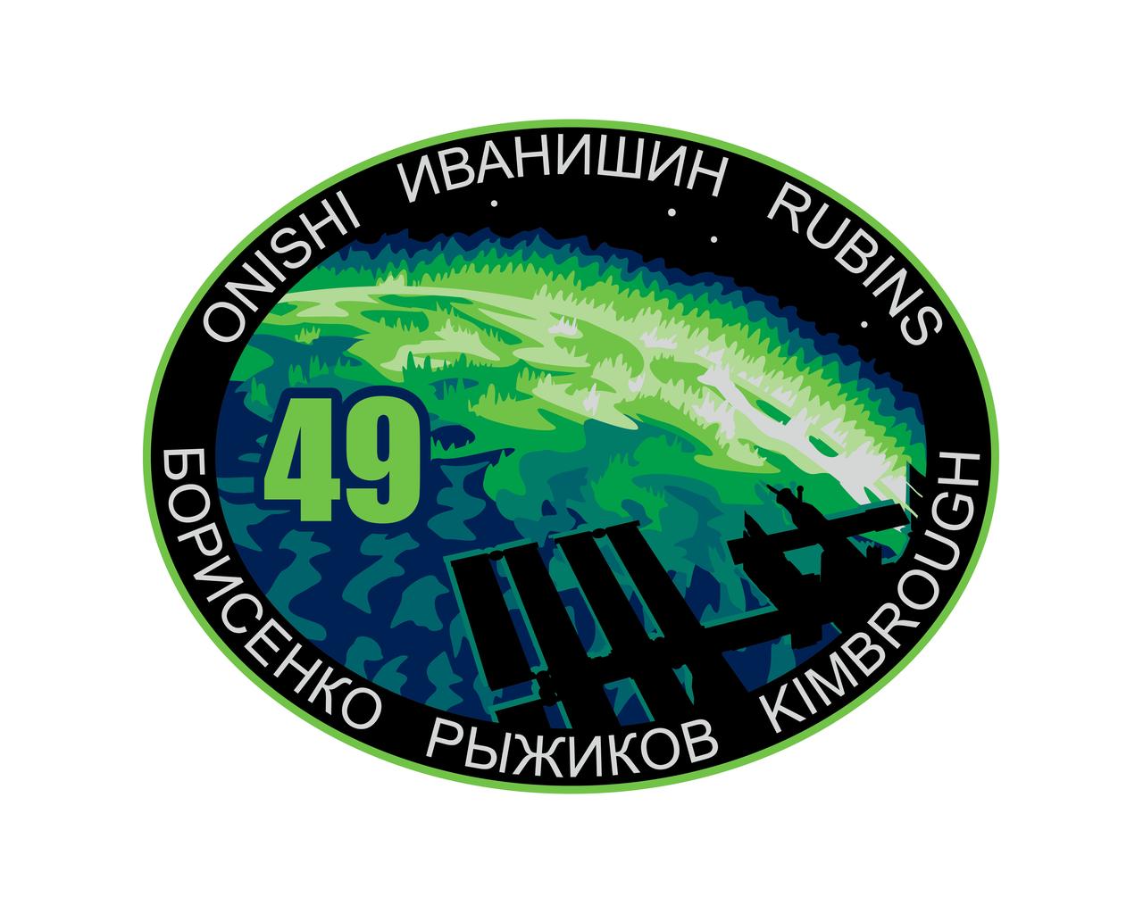 ISS049-S-001 --- The Expedition 49 patch shows the International Space Station (ISS) coming into view over an aurora extending past Earth’s horizon. This depiction emphasizes the benefits to Earth of research conducted on the ISS as well as the global nature of the international partnerships vital to this endeavor. The green hue in the aurora is symbolic of life on our home planet. The crew of Expedition 49 will be working “Off the Earth, for the Earth.”