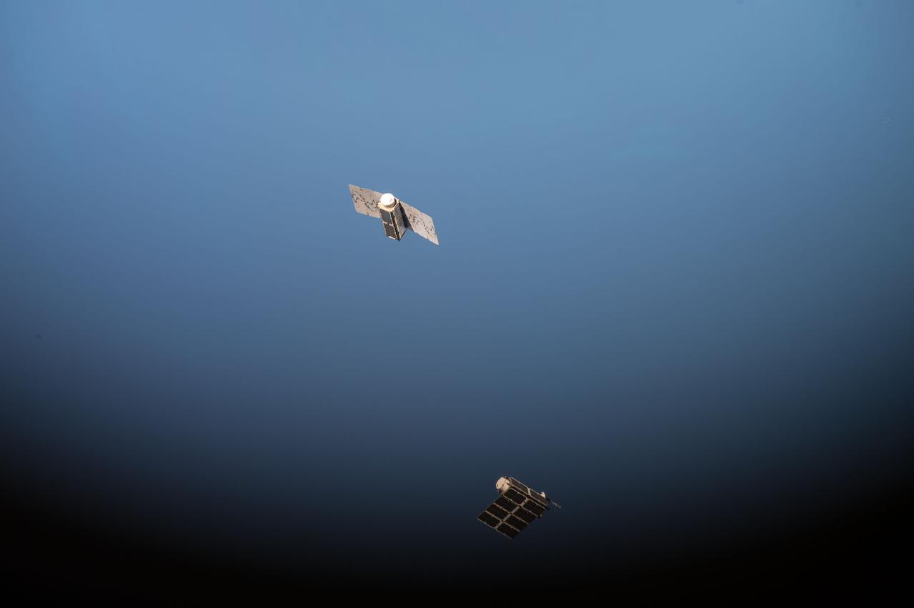 View taken by the Expedition 49 crew of track of first of four pairs of Planet Lab DoveSats over the Earth. This deployment titled “Flock 2” is a fleet of nanosatellites designed, built and operated by Planet Labs Inc., and will enable imagery of the changing planet to be taken on a frequent basis, with humanitarian and environmental applications ranging from monitoring deforestation and the ice caps to disaster relief and improving agriculture yields in developing nations. Image used as part of Twitter message - We launched two satellites from @Space_Station today – like skydivers soaring towards the earth." #AstroKate.