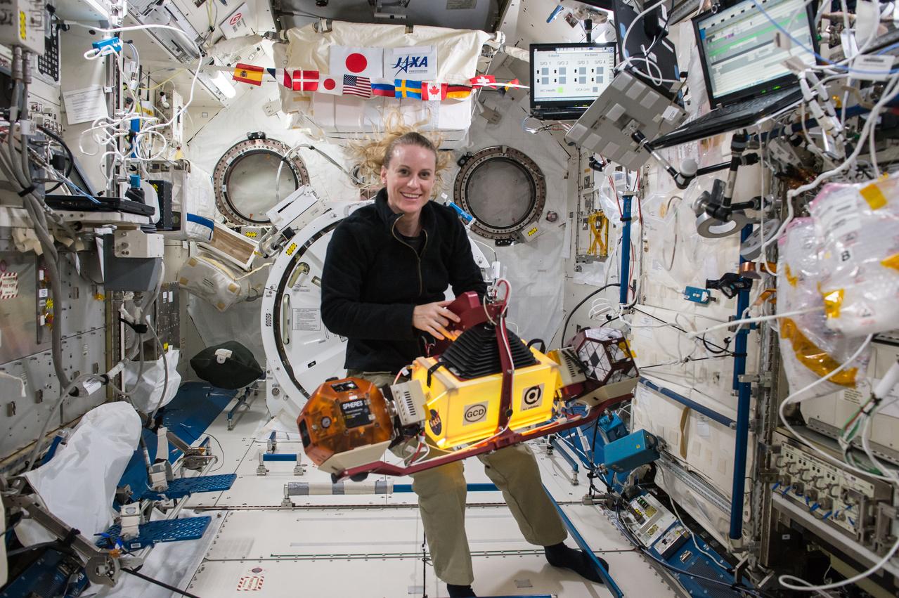 iss049e033811 (10/7/2016) --- NASA sstronaut Kate Rubins is photographed configuring the SPHERES-Slosh experiment setup using two SPHEREs satellites and the slosh assembly. The SPHERES-Slosh investigation examines the way liquids move inside containers in a microgravity environment.