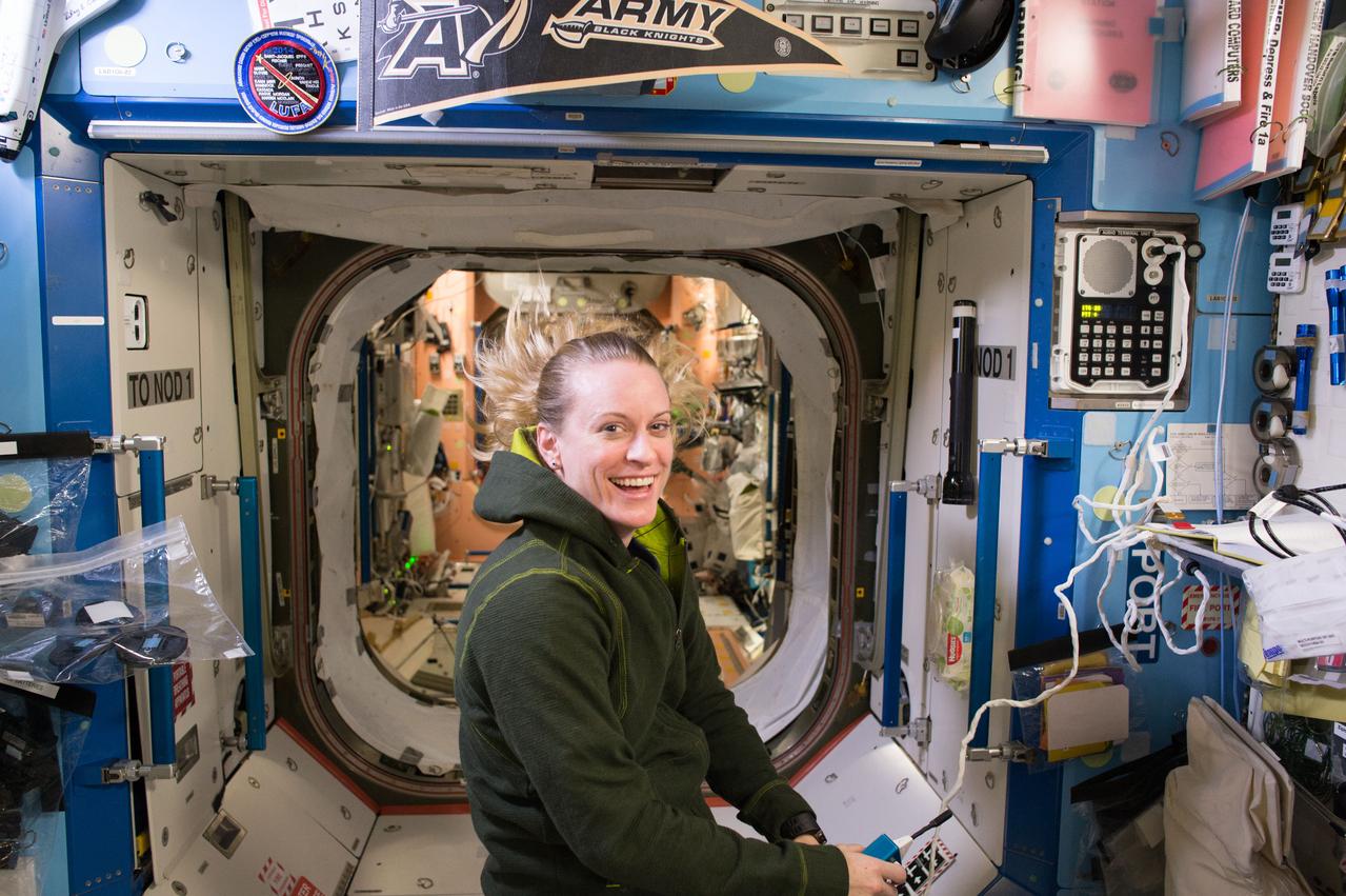 ISS049e038794 (10/14/2016 --- NASA astronaut Kate Rubins holds a communication microphone while floating in the U.S. Destiny Laboratory aboard the International Space Station. Rubins, a first time flier with a degree in molecular biology, is scheduled to return to Earth on Oct. 29, 2016, U.S. time