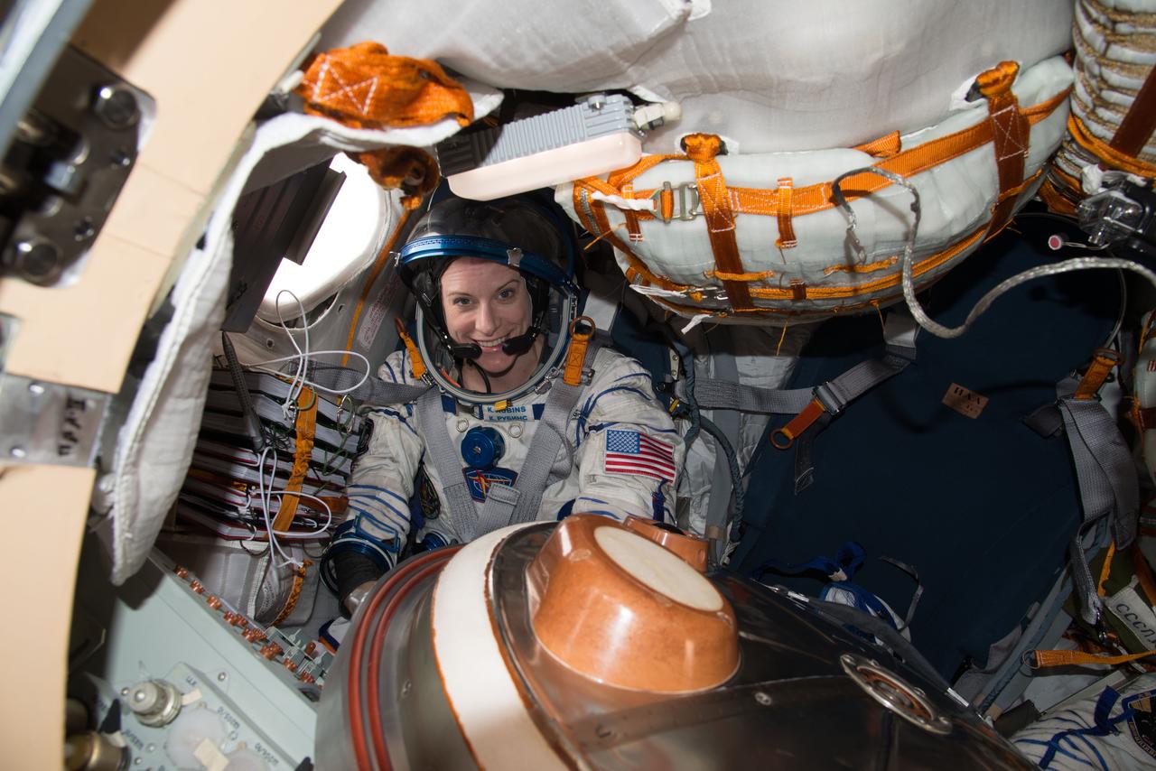 ISS049e040733 (10/19/2016) --- NASA astronaut Kate Rubins is pictured inside of the Soyuz MS-01 spacecraft while conducting routine spacesuit checks. Rubins, suited up in a Russian Sokol Launch and Entry suit, was conducting leak checks in advance of her upcoming landing along with Japanese astronaut Takuya Onishi and Russian cosmonaut Anatoly Ivanishin. The trio are scheduled to land Oct. 29, U.S. time.