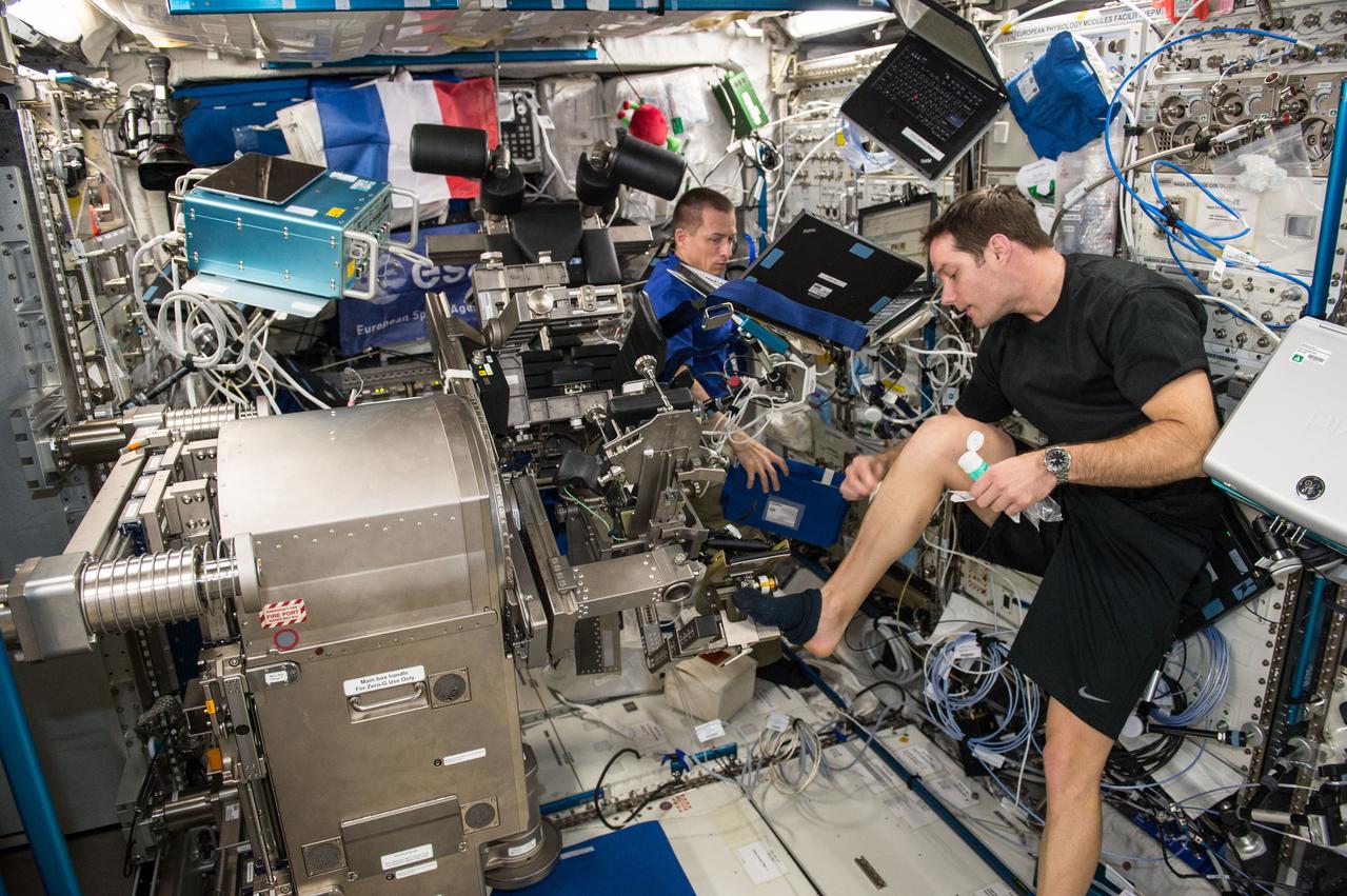 iss050e012767 (11/29/2016) --- European Space Agency (ESA) Thomas Pesquet and Cosmonaut Sergei Ryzhikov during the setup phase of the Sarcolab-3 Experiment, by deploying and configuring the Muscle Atrophy Resistive Exercise System (MARES), in the Columbus Module.    Myotendinous and Neuromuscular Adaptation to Long-term Spaceflight (Sarcolab) investigates the adaptation and deterioration of the soleus, or calf muscle, where it joins the Achilles tendon, which links it to the heel and carries loads from the entire body. Muscle fiber samples are taken from crew members before and after flight, and analyzed for changes in structural and chemical properties.