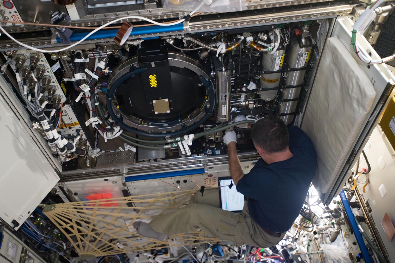 iss050e020199 (12/29/2016) --- NASA astronaut Shane Kimbrough reconfiguring the Combustion Integrated Rack (CIR) High Bit Depth/Multispectral (HiBMS) imaging packages at Universal Mounting Location (UML) 7 and UML 8. The CIR is used to perform combustion experiments in microgravity and can be reconfigured easily on orbit to accommodate a variety of combustion experiments.