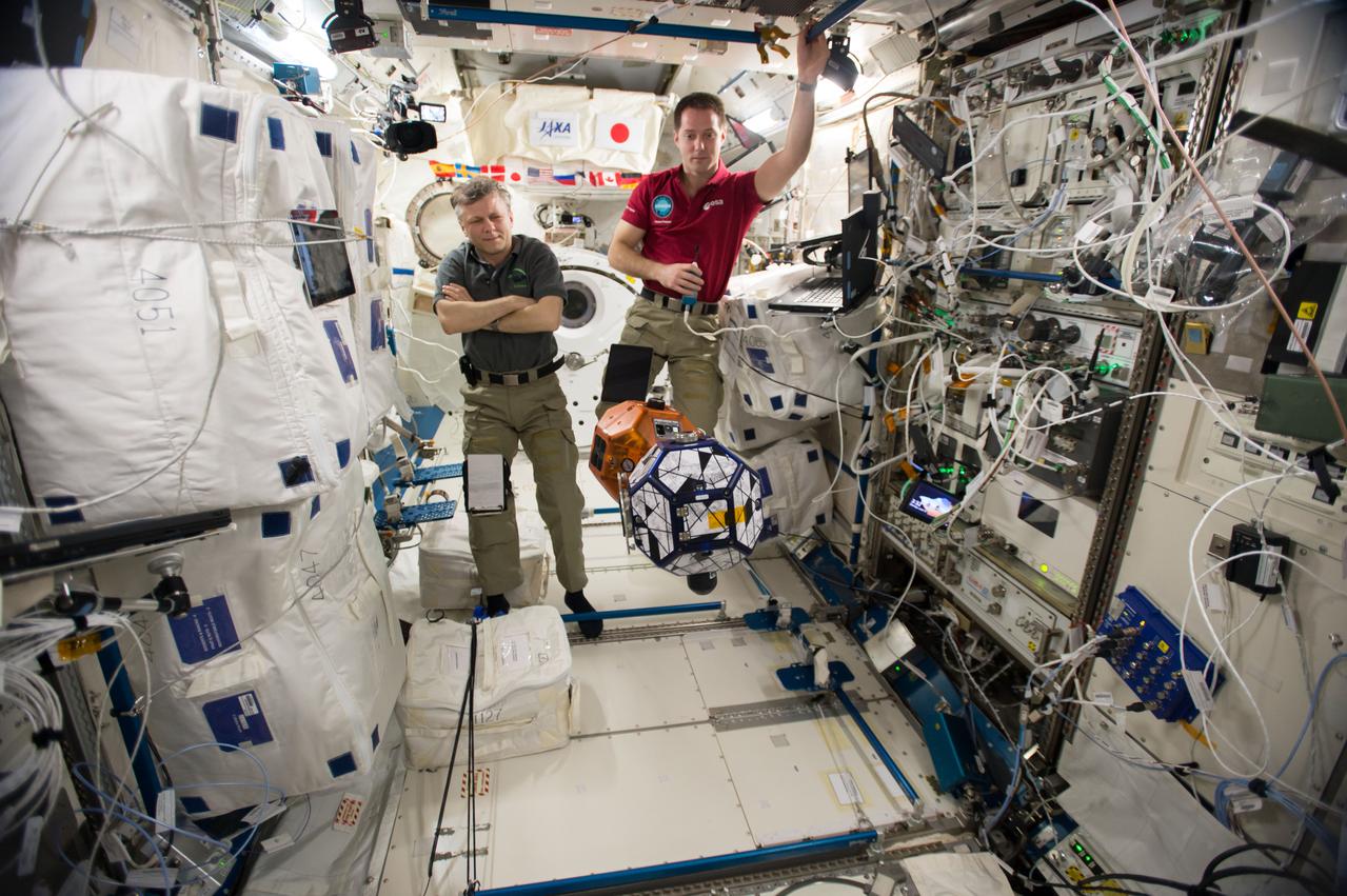 iss050e031138 (1/16/2017) --- A view of Cosmonaut Andrei Borisenko, and European Space Agency (ESA) astronaut Thomas Pesquet during set up and execution of Synchronized Position Hold, Engage, Reorient, Experimental Satellites (SPHERES) hardware dry run for the Zero Robotics, in the Japanese Experiment Module (JEM) Pressurized Module.