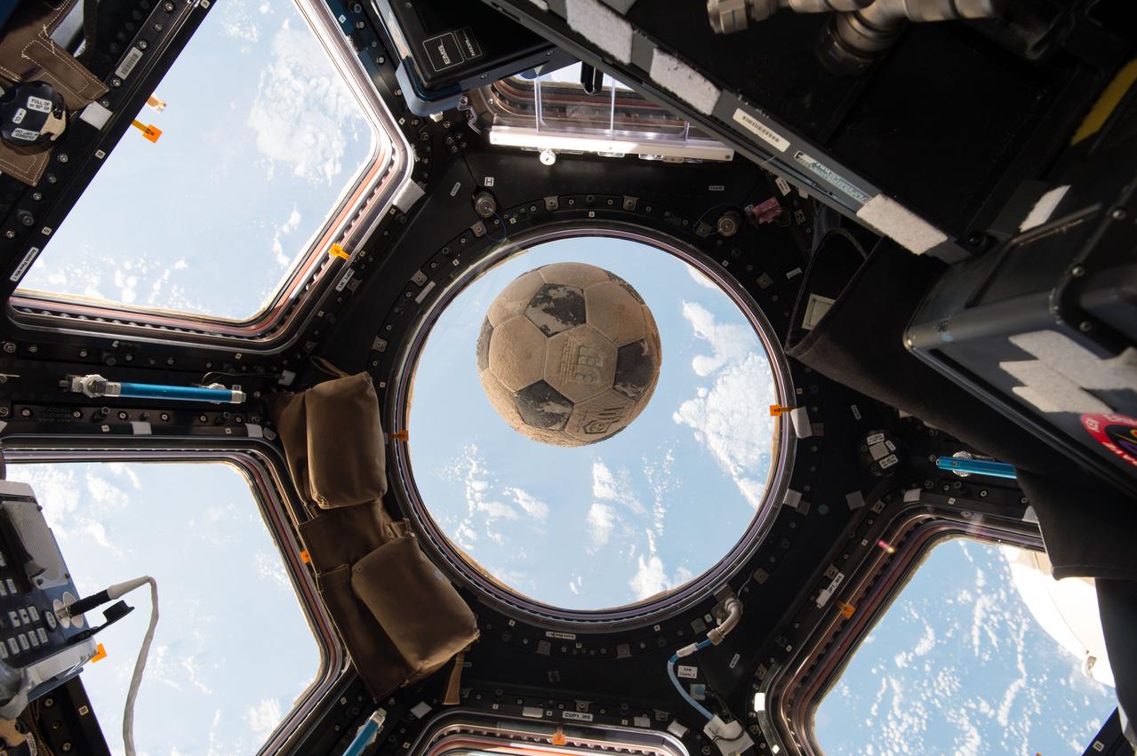 iss050e033912 (01/21/2017) --- A soccer ball originally packed onto space shuttle Challenger in 1986 is now orbiting the Earth on board the International Space Station, 31 years later. The soccer ball was signed and presented to NASA astronaut Ellison Onizuka by soccer players – including his daughter – from Clear Lake High School, near NASA’s Johnson Space Center. Onizuka was one of seven astronauts on board Challenger on Jan. 28, 1986, when it exploded shortly after liftoff. Following the accident, the ball was recovered and returned to the high school, where it has been on display for the past three decades. Its history had begun to fade into obscurity when Principal Karen Engle learned of its origin. Soon after, astronaut Shane Kimbrough, whose son attends Clear Lake High School, offered to carry up a memento on the school’s behalf, and she had the idea to send the soccer ball into space. Kimbrough snapped this photo of the ball floating in front of the station’s Cupola window in advance of Challenger anniversary and NASA’s Day of Remembrance.