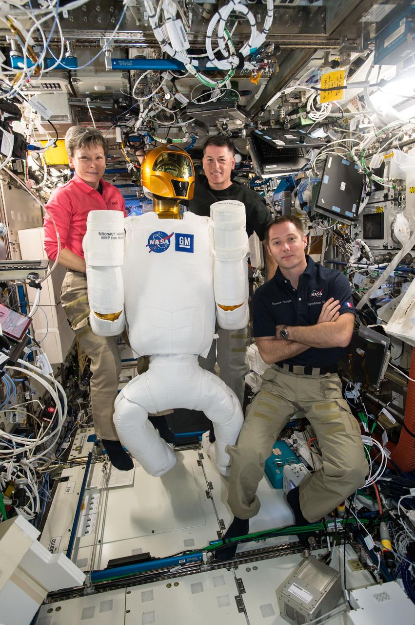 iss050e037542 (2/1/2017) --- NASA astronauts Peggy Whitson, Shane Kimbrough and European Space Agency (ESA) astronaut Thomas Pesquet,  posing with Robonaut, in the U.S. Laboratory. Robonaut is a humanoid robot designed with the versatility and dexterity to manipulate hardware, work in high risk environments, and respond safely to unexpected obstacles. Robonaut is comprised of a torso with two arms and a head, and two legs with end effectors that enable the robot to translate inside the ISS by interfacing with handrails and seat track.